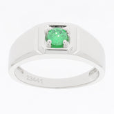 Round green emerald sterling silver ring with elegant design, showcasing a sparkling gemstone in a modern setting.